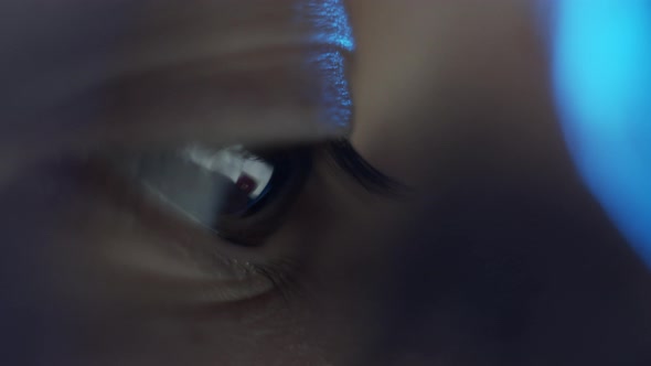 Macro view of laptop screen reflection in brown human eye. Surfing internet social media. Computer