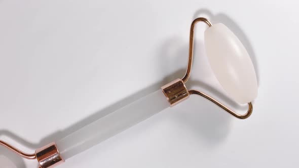 White Massage Quartz Roller for the Face Closeup Isolated on a White Background alt