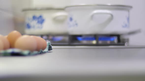 Rack focus of cooking pots on a stove alt