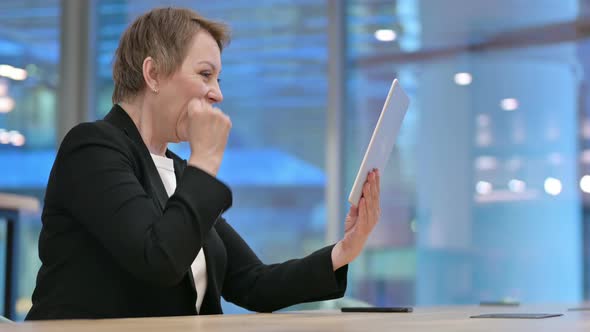 Old Businesswoman Celebrating Success on Tablet alt