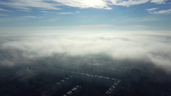 Aerial Drone View Flight Over Above Fog Mist and Roofs of Buildings in City alt