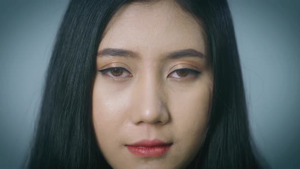 A close up portrait on a beautiful Asian woman face looking at the camera, biometric retina recognit alt