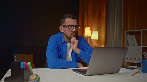 Thoughtful Serious Man Sit at Home Office Desk with Laptop Thinking of Inspiration Search Problem alt