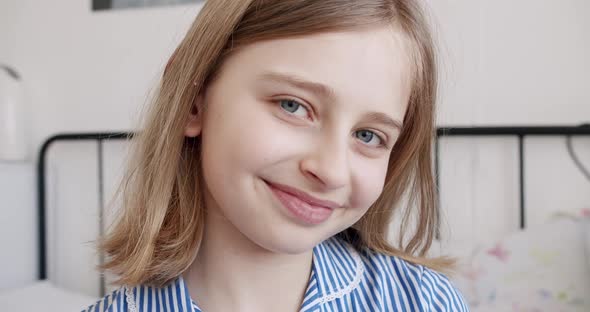 The Teenage Girl Looks at Camera and Smiles alt