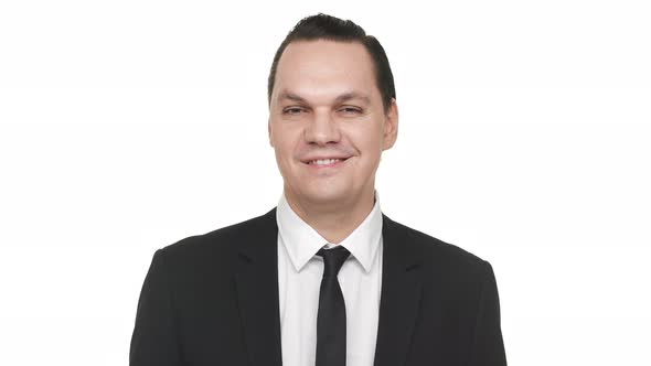 Portrait of Content Businessman 30s in Black Business Suit Smiling and Expressing Gladness Over alt