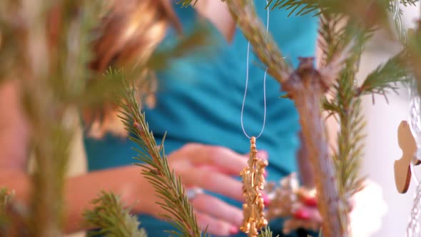 Slow Motion Girl Decorates Christmas Tree with Snowflakes alt