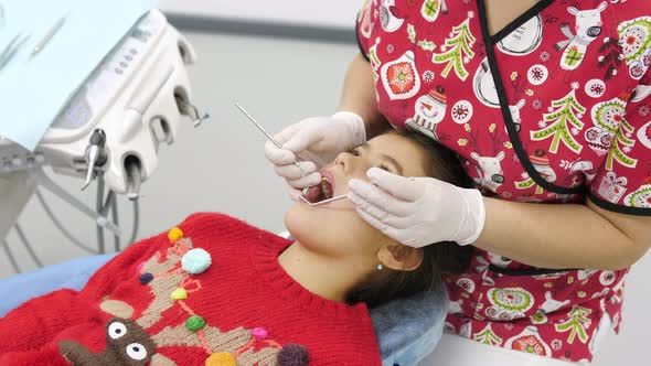 Little girl being treated by a dentist alt