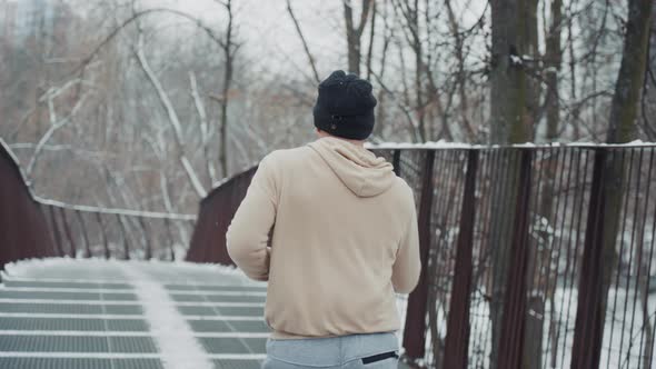 Slow Motion Man Jogging on Bridge in Winter alt
