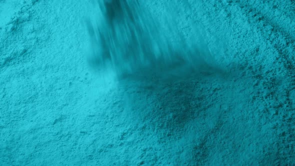 Cyan Powder Pours Into Pile alt