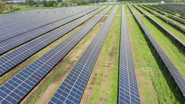 Aerial View of Solar Power Station. Solar Farm. Field of Solar Panels in a Row alt