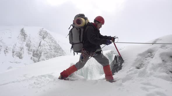 Mountaineer Next To A Crack In Glacier