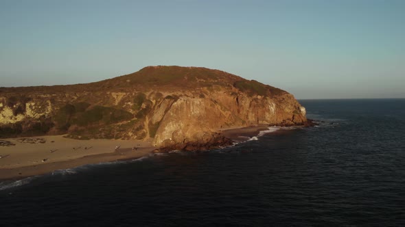 An Aerial Shot of the Point Dume Cliffs in Malibu in California in the Evening as the Vibrant Sun Se alt