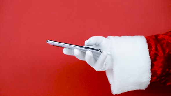 Santa Claus Hand Holding Smartphone Blank Screen alt