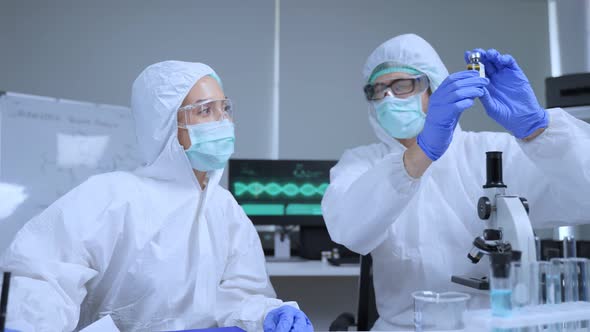 Researcher doctor in PPE work in laboratory room of covid-19 vaccine and drug manufacturing company. alt