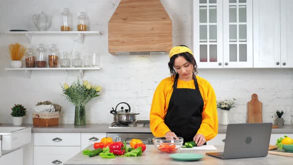 Woman Slices Cucumber Listen Teacher Chef Study Online Video Call Webcam Laptop alt