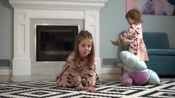 Picture of Beautiful Two Little Children Wearing Dresses Having Fun and Playing Games While Resting