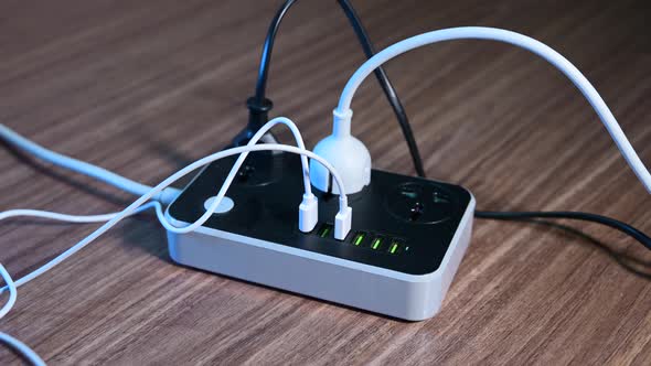 Male Hand Unplugging Cables From the Power Outlet alt