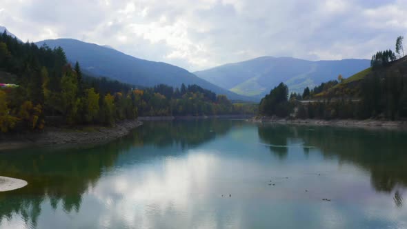 Aerial Footage Above a Lago di Valdaora lake on a rainy day
