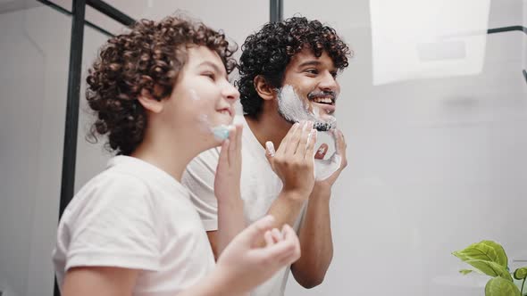 Curlyhaired Brothers Put Shaving Cream on Face in Morning alt