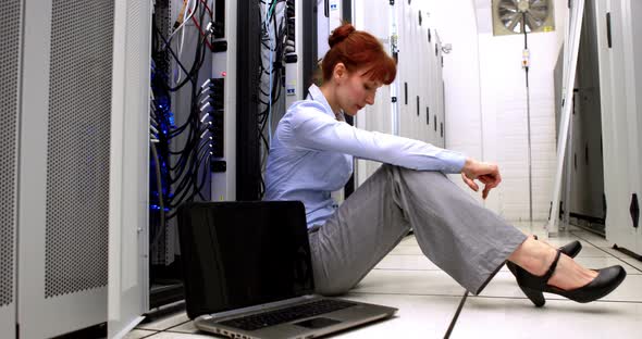 Stressed Technician Sitting on Floor Beside Open Server alt