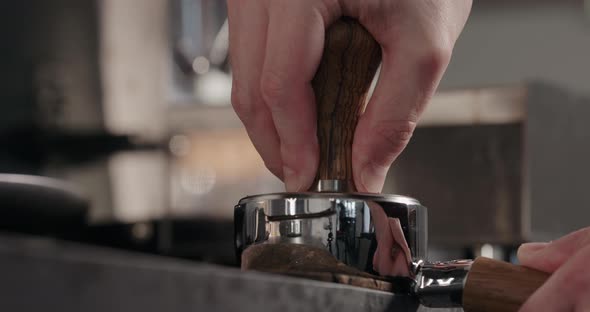 Slow Motion Tamping Fresh Ground Coffee in Basket of Bottomless Portafilter alt