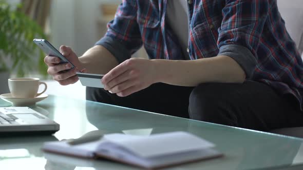 Man Typing Credit Card Data Into Smartphone, Shopping Online, Cybersecurity alt