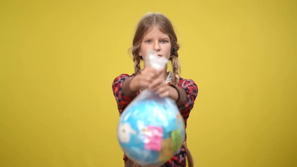Front View Serious Female Adolescent Ecoactivist Looking at Camera Stretching Earth Globe in Plastic alt