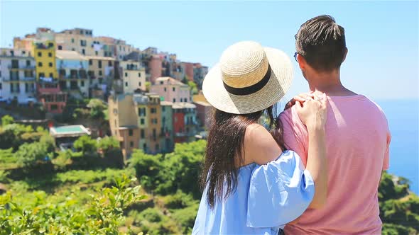 Happy Family with View of the Old Coastal Town Background of Corniglia, Cinque Terre National Park