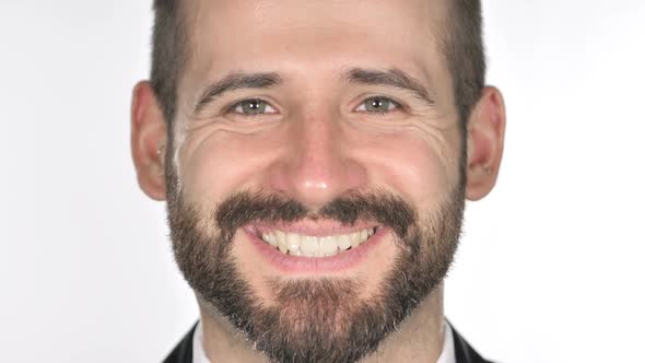 Close Up of Smiling Beard Businessman Face White Background alt
