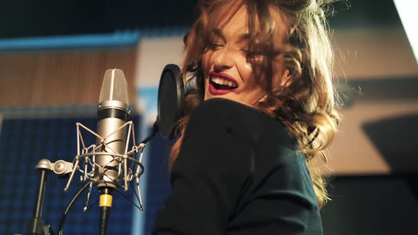 Beautiful young singer who recorded a song in a professional recording studio. Female vocal alt