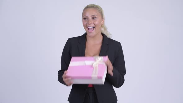 Young Blonde Businesswoman Opening Empty Gift Box As Prank alt