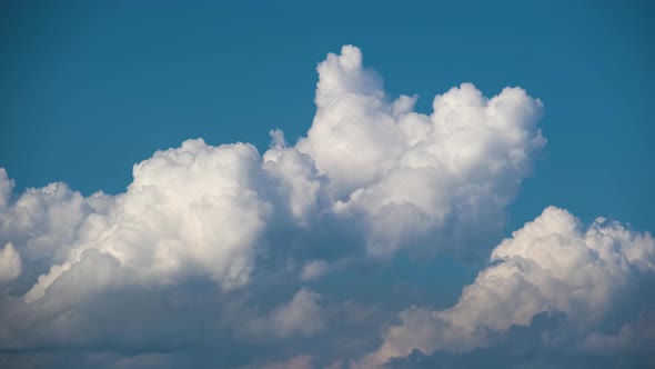Timelapse of White Puffy Cumulus Clouds Forming on Summer Blue Sky alt