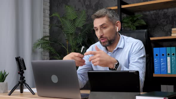 Smiling Man Trader Talks Online Laptop with Investor Company on Stock Exchange alt