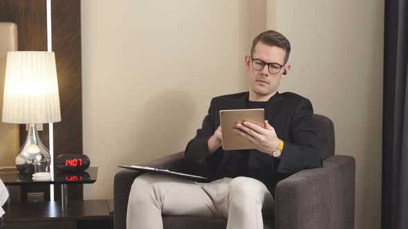 Entrepreneur Man Use Digital Tablet Sitting in Hotel Room