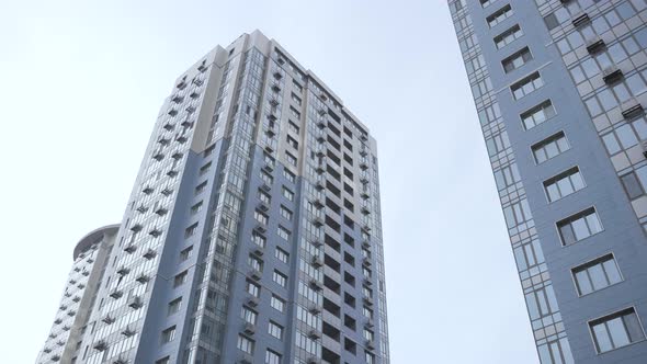 Food Delivery Man Carrying Bike Among Skyscrapers alt