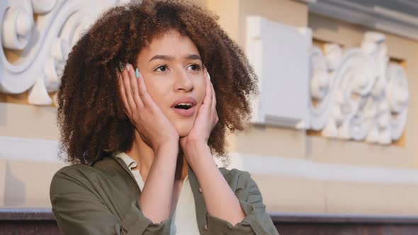 Happy Young Attractive African American Female Tourist with Curly Hair Emotionally Surprising alt