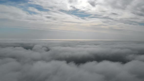 Flying Over Gray Clouds. Bad Weather in the City