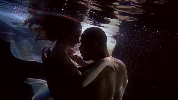 Man And Woman Are Having Sex Underwater In Dark Depth Of Pool Brawny