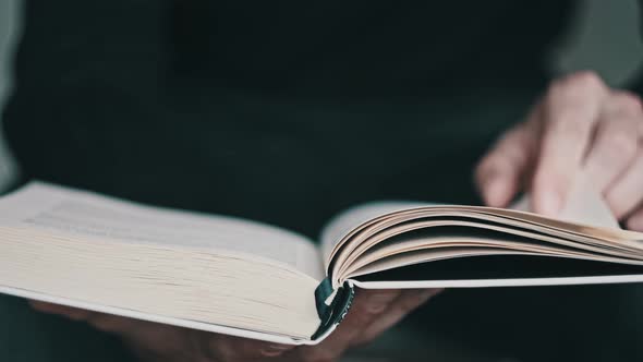 Reading a Book and Turning the Pages Close Up Slow Motion alt