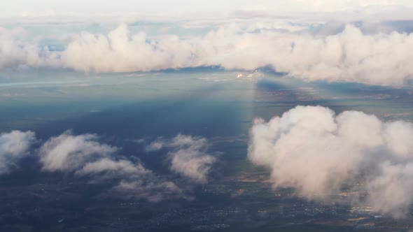 Plane soaring through cloud, aerial view of city and ocean nature landscape winter slow motion video