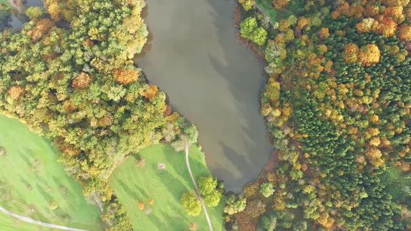 Aerial Above Lake with Autumn Foliage and Tree Reflections in Styria Thal Austria