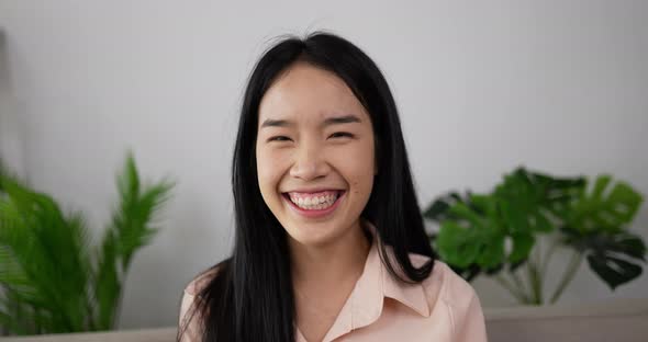 Asian woman laughing alt