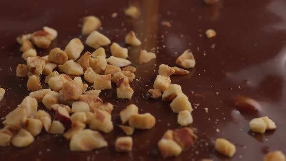 Nuts falling onto melted chocolate