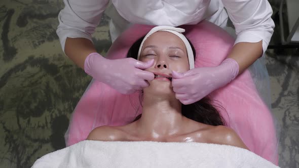 Facial Massage Procedure for a Beautiful Woman in a Beauty Salon