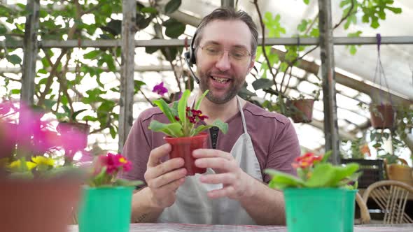 Man Sells Flowers and Seedlings Via Video Link on a Laptop Via the Internet