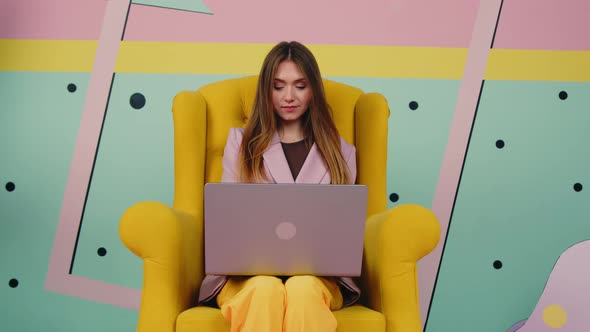 Bossy Woman Is Working In Soft Yellow Armchair