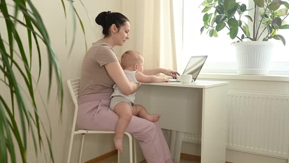 Young Mother Work Studying From Home with Laptop Computer During Quarantine Little Cute Toddler Baby