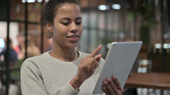 Cheerful African Woman Using Tablet PC alt