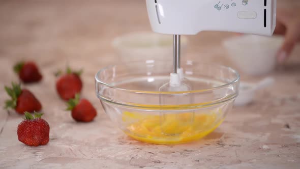 Electric Mixer Beaters Beating Eggs.
