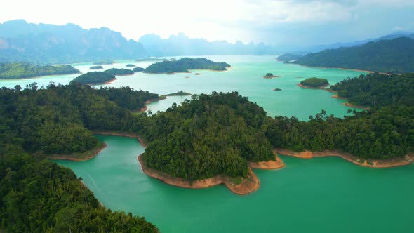 An aerial view from a drone flying over a dam, beautiful turquoise water alt